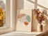 Minimalist one line brain anatomy print displayed by a bright window