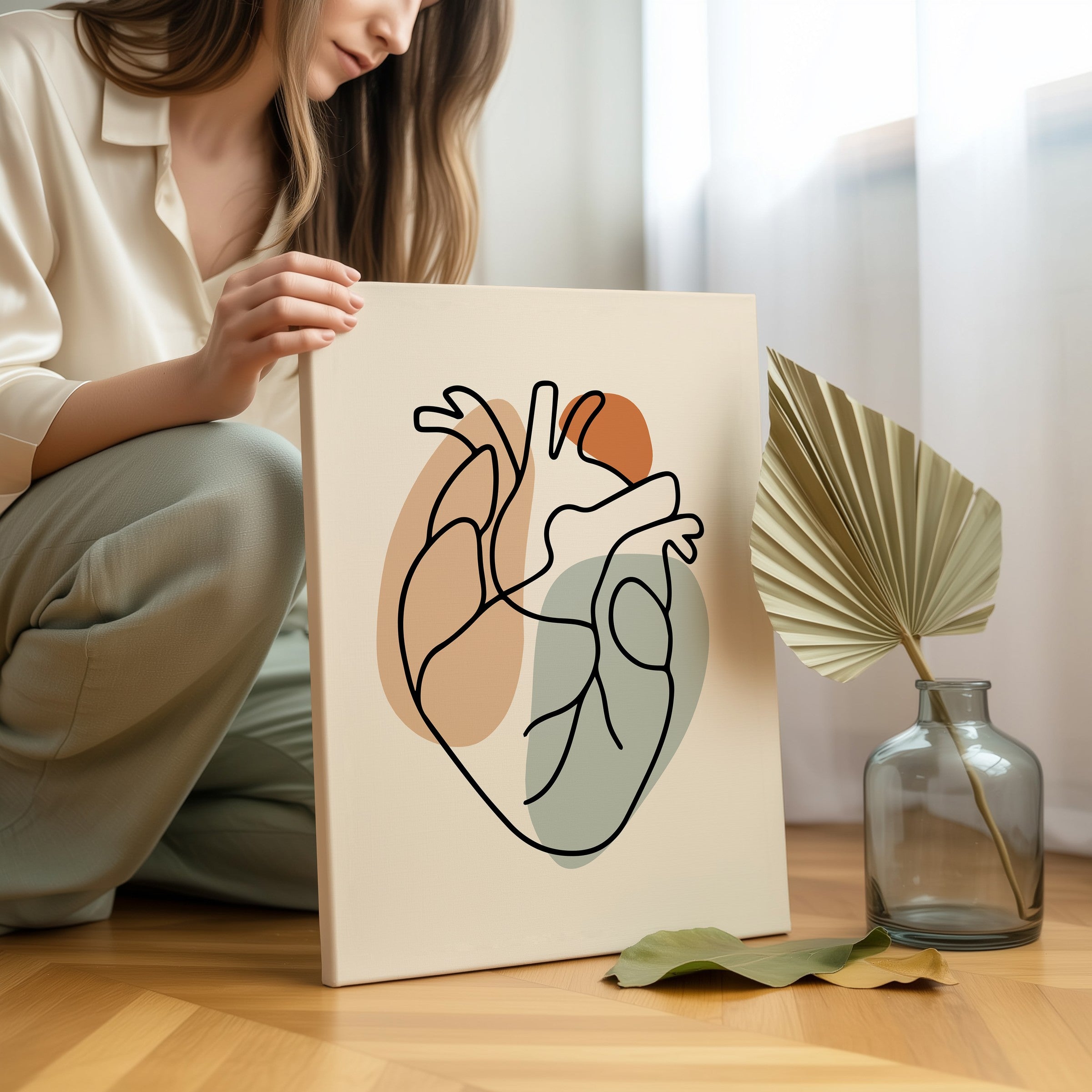 Person holding one line heart artwork in a light room