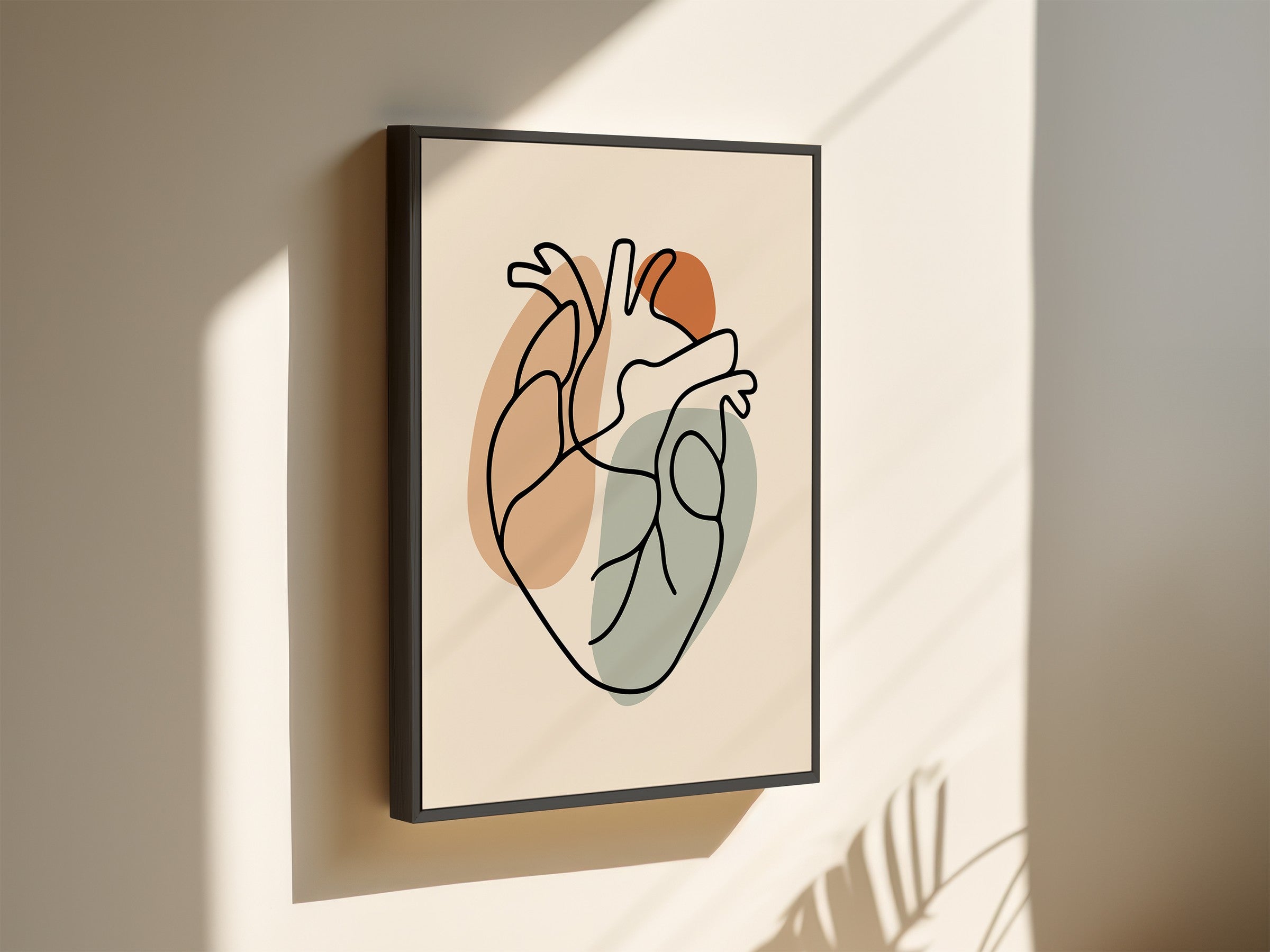One line heart artwork in a black frame on a light wall