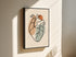 One line heart artwork in a black frame on a light wall