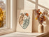 Unframed thick heart canvas leaning beside a window and vase