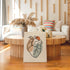 One line heart artwork on a thick unframed canvas beside a window