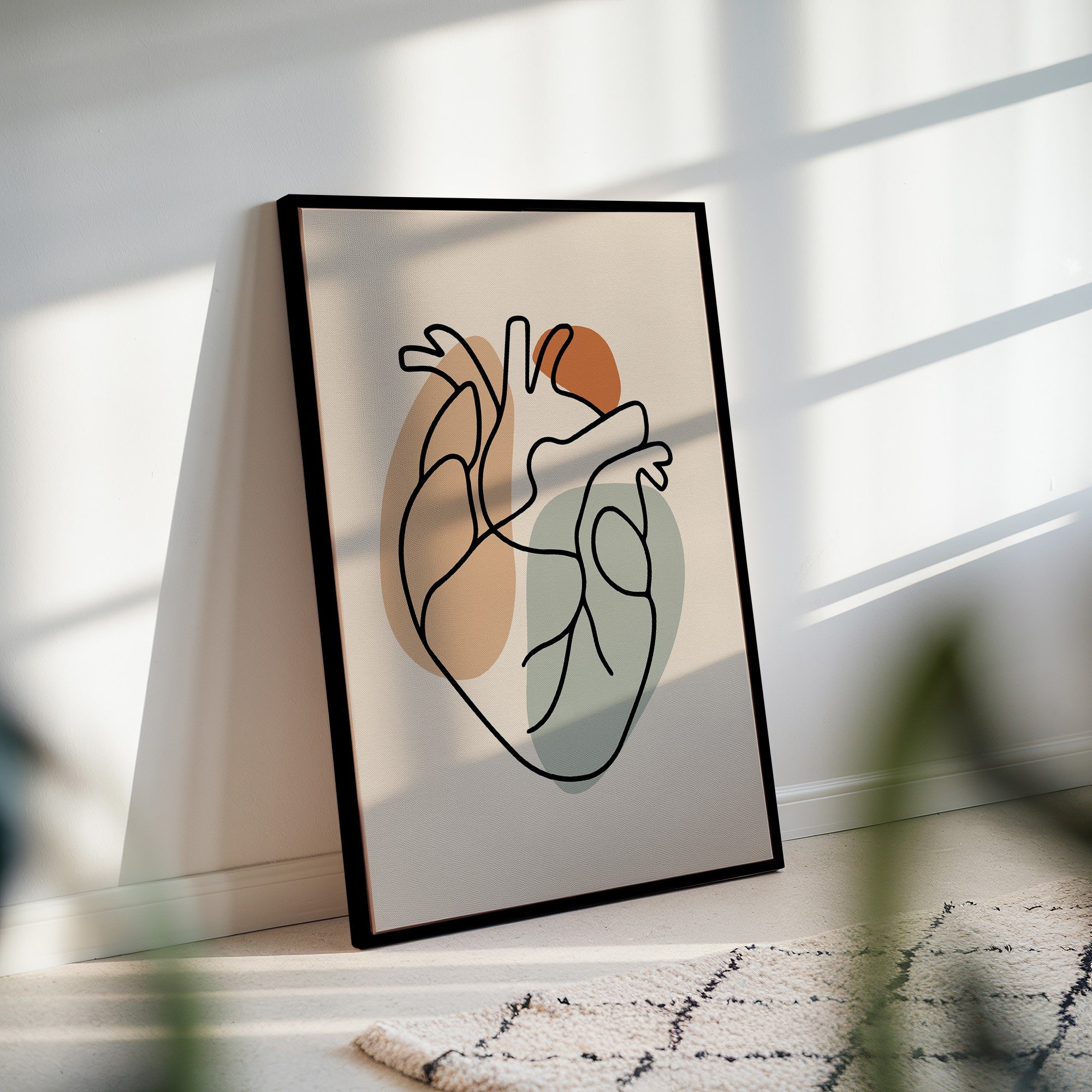 Black framed one line heart artwork styled in a neutral room