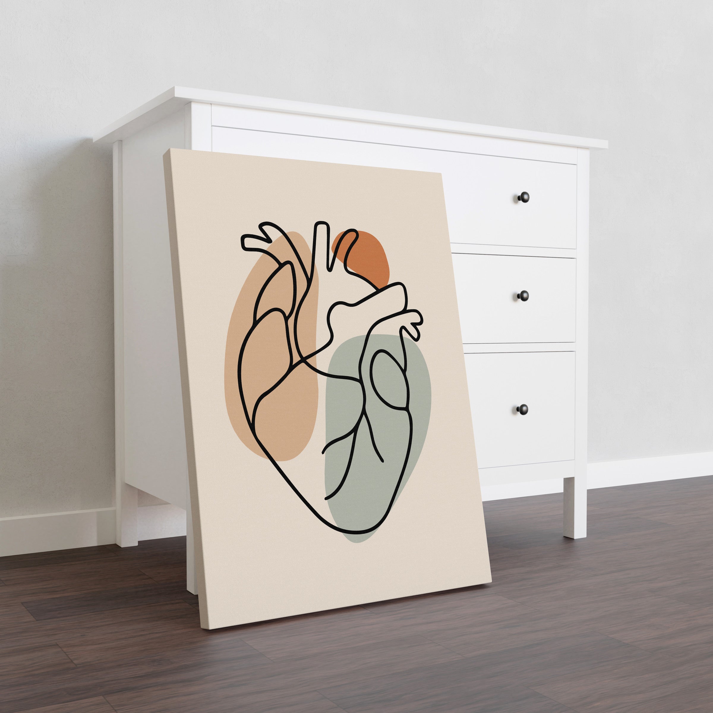 One line heart artwork on a thick unframed canvas leaning beside a white dresser