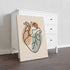 One line heart artwork on a thick unframed canvas leaning beside a white dresser