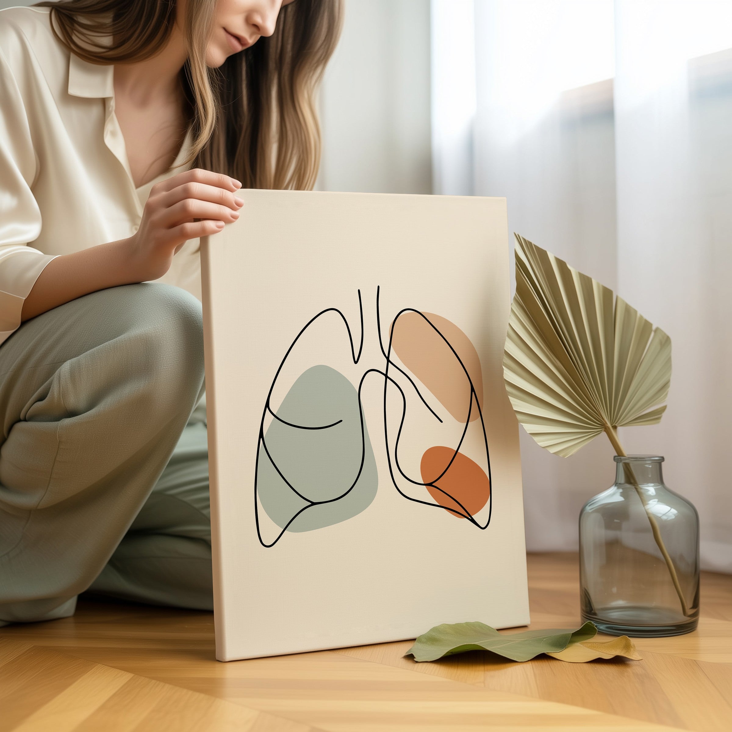 Person holding one line lungs artwork in a light room