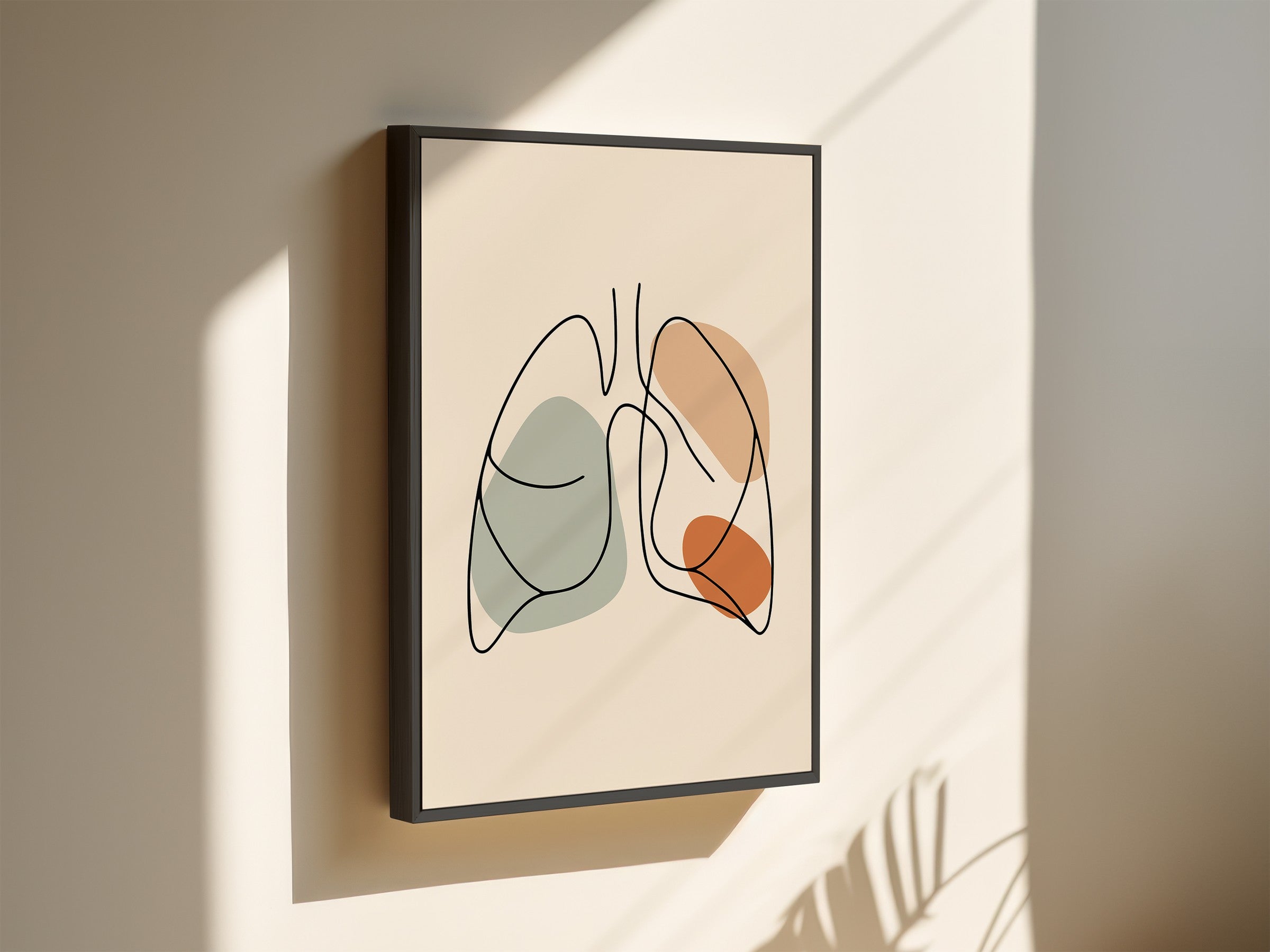 One line lungs artwork in a black frame on a light wall