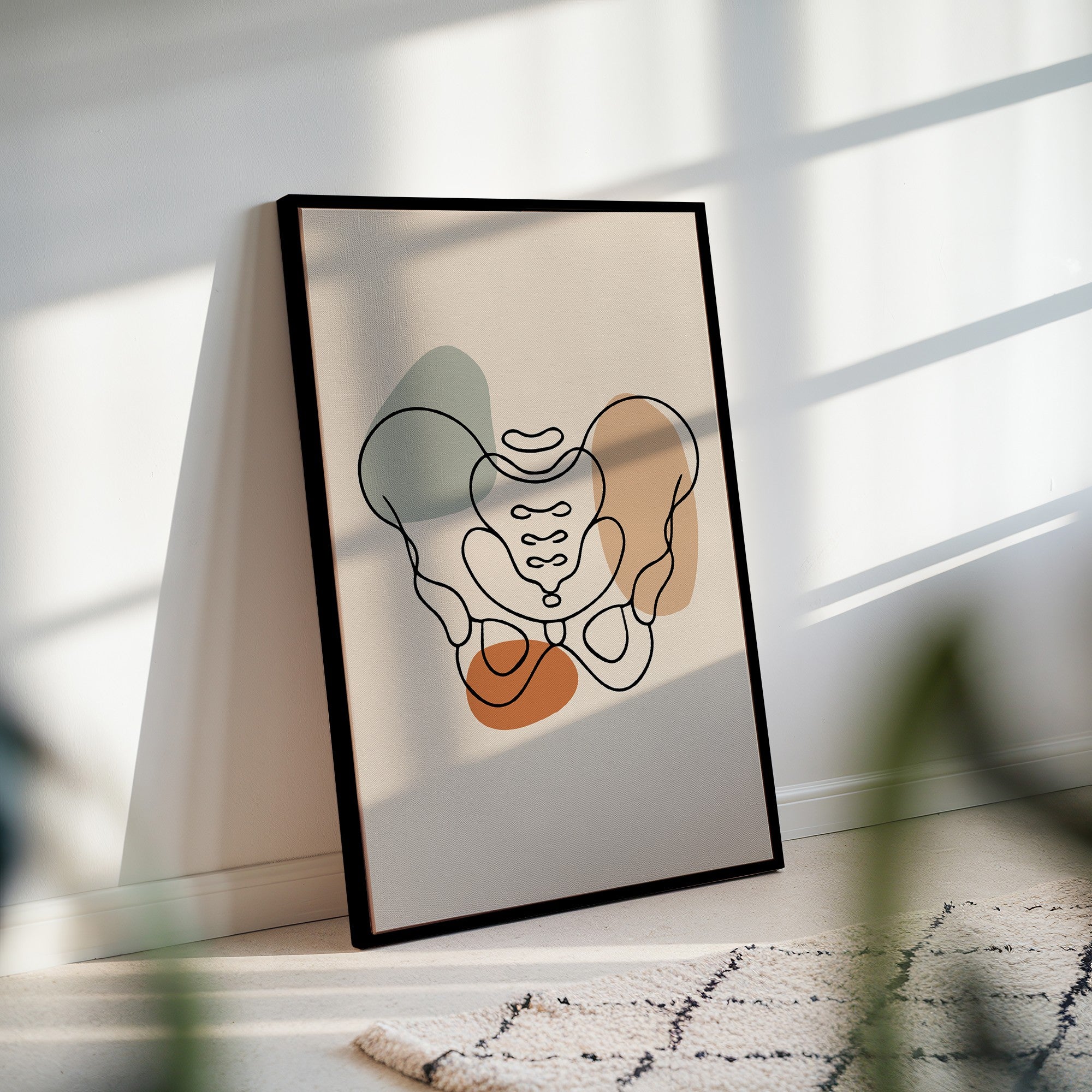 Framed pelvis canvas leaning against a wall in sunlight with soft striped shadows.