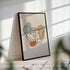 Framed pelvis canvas leaning against a wall in sunlight with soft striped shadows.