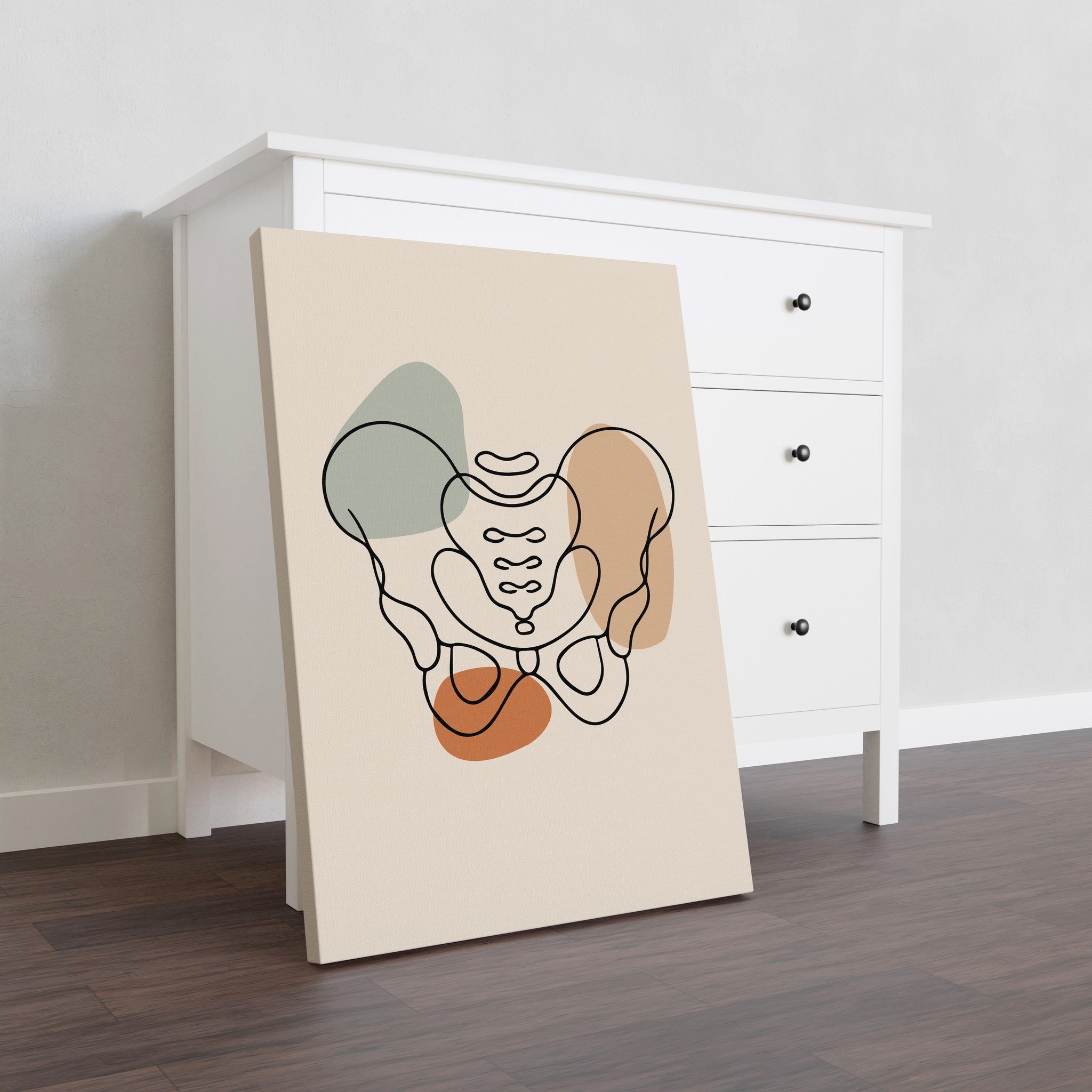 Pelvis line art on stretched canvas without an outer frame, leaning against a white dresser.