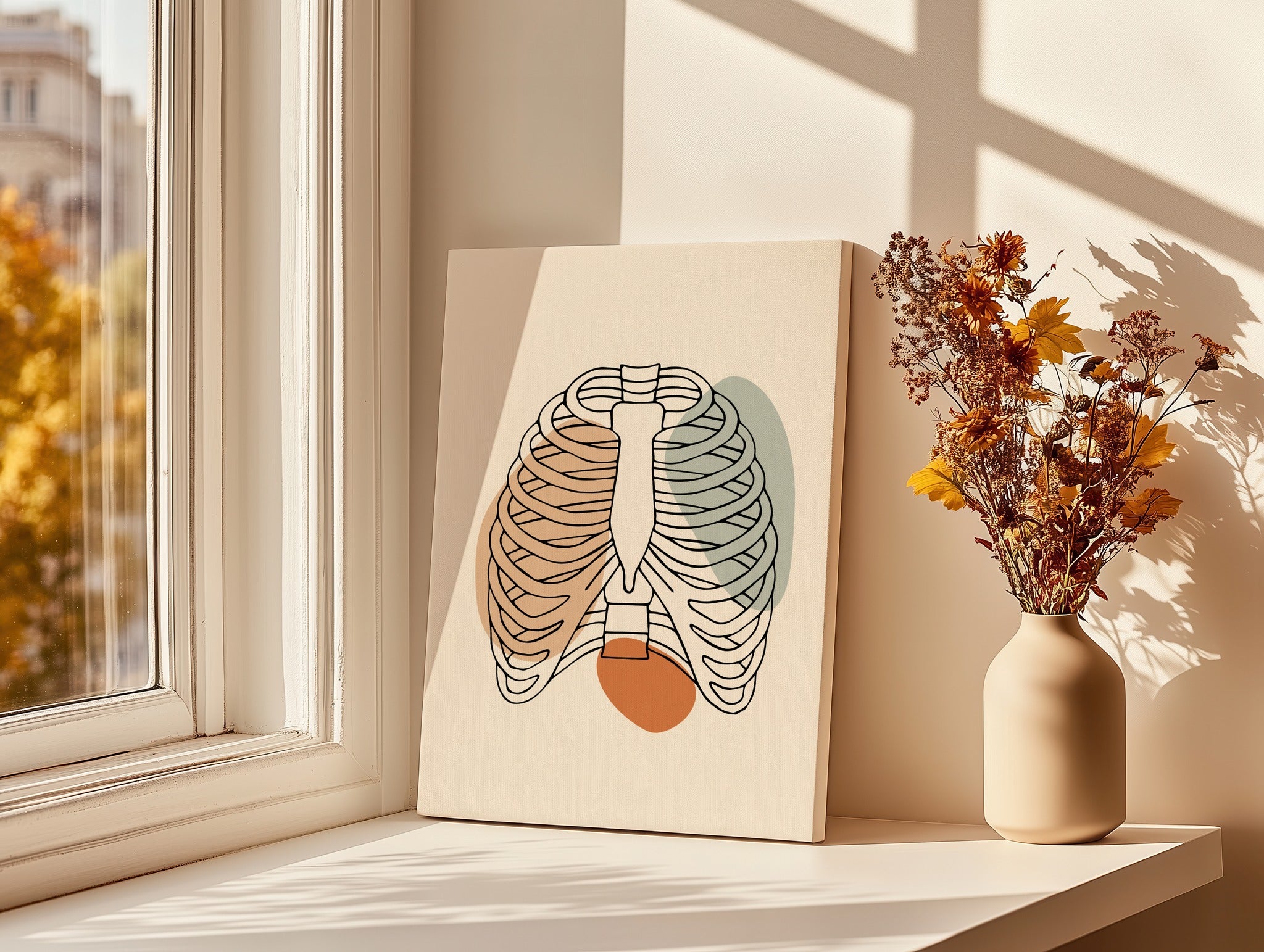 Minimalist rib cage line art displayed beside a bright window.