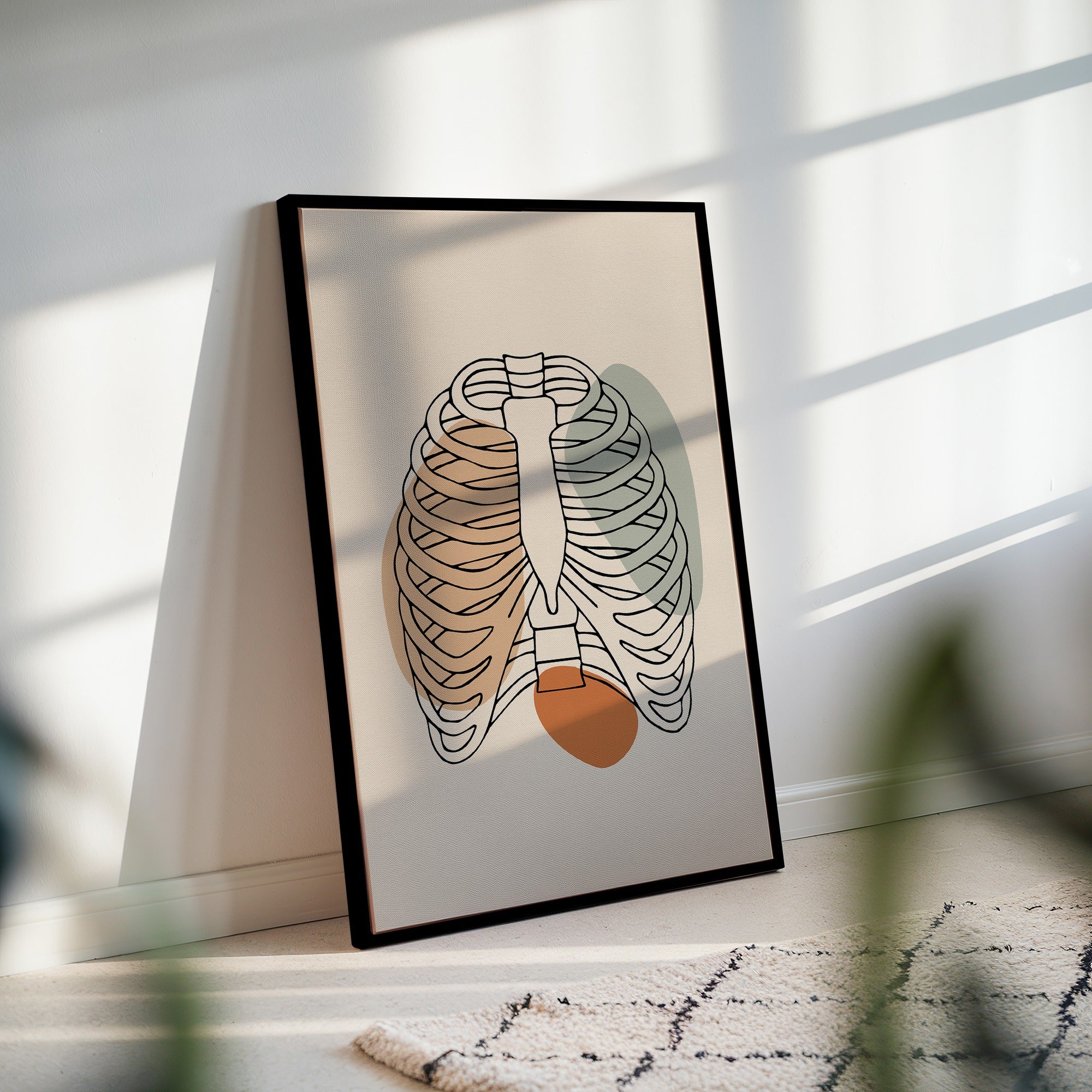 Minimalist rib cage line art in a black frame with striped sunlight across the wall.