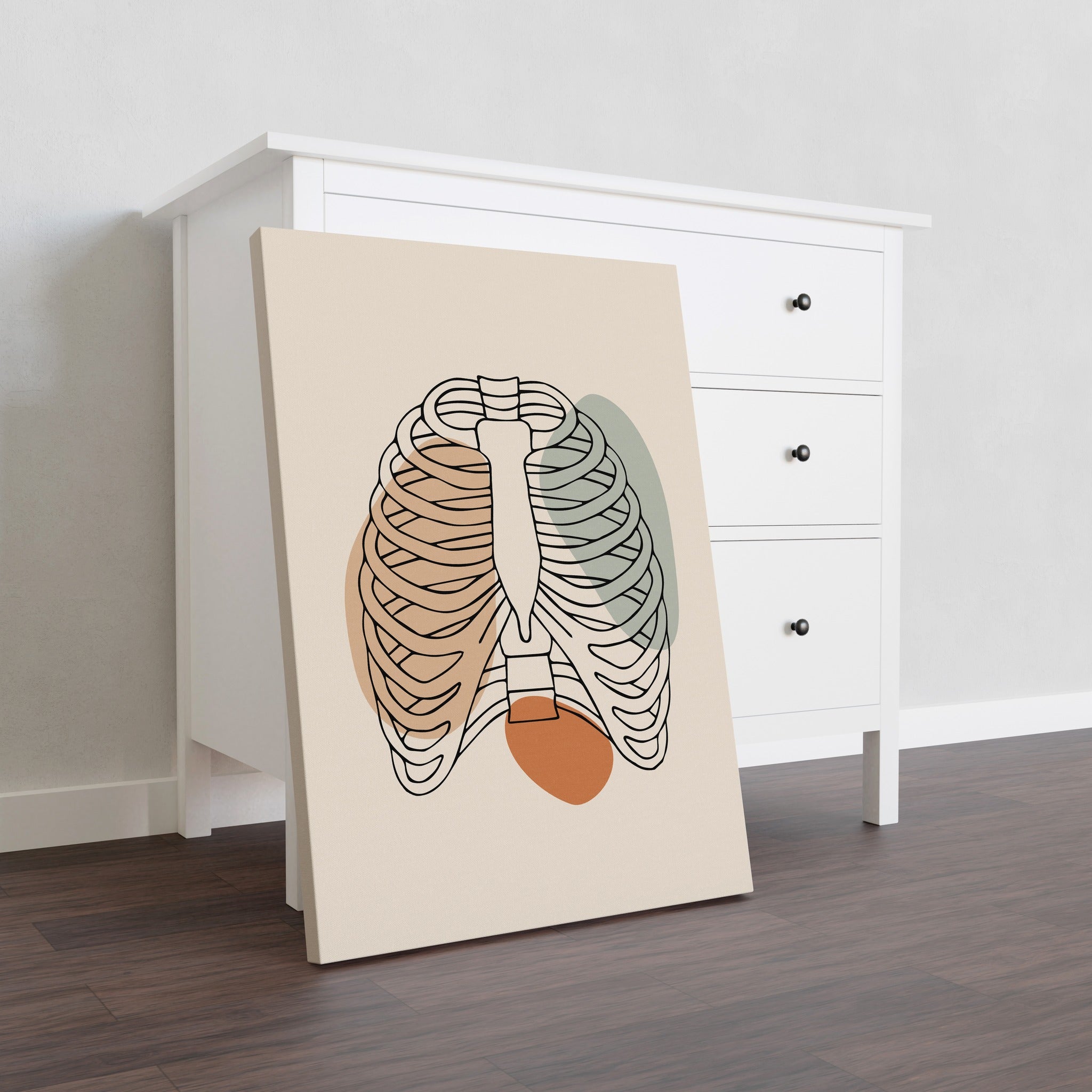 Minimalist rib cage line art on stretched canvas beside a dresser.