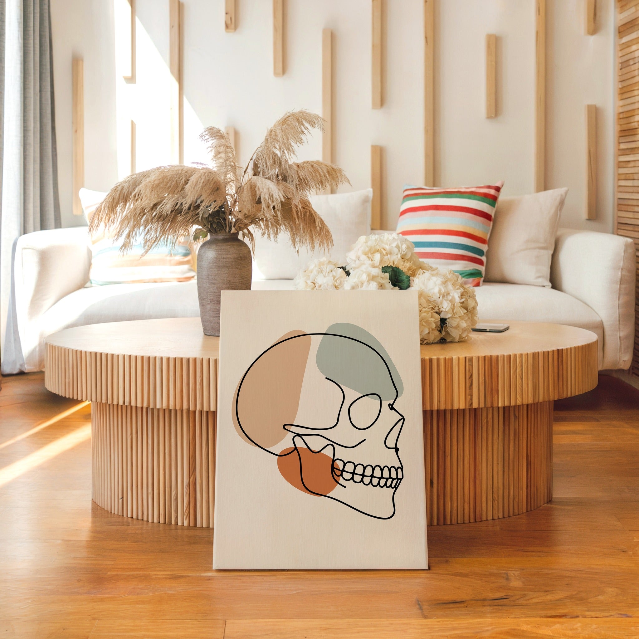Minimalist skull line art displayed in a neutral living room.