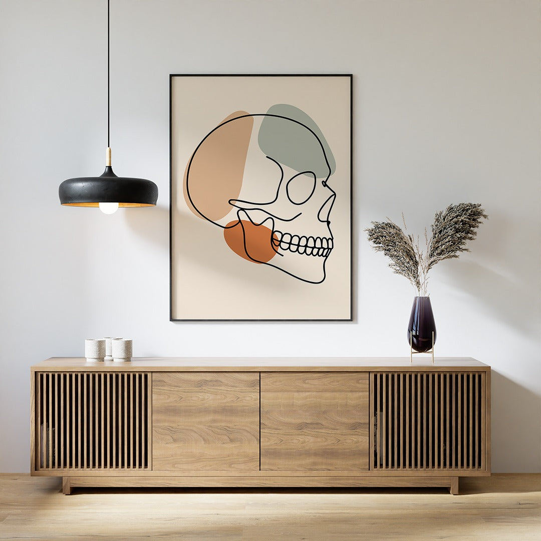 Minimalist skull line art in a room above a sideboard.