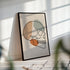 Minimalist skull line art in a black frame with striped sunlight across the wall.