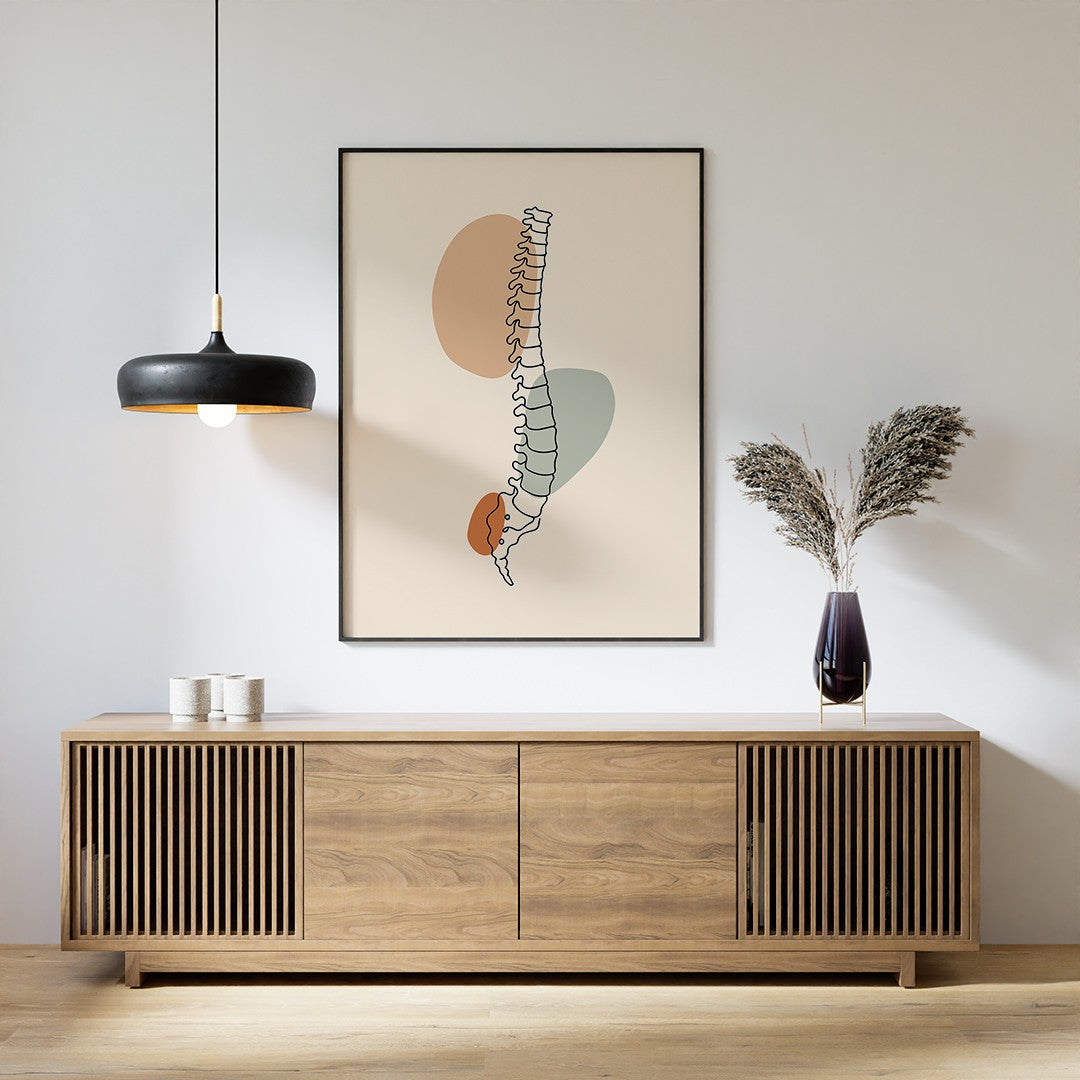 Black-framed spine line art above a wooden sideboard with a pendant lamp and vase.